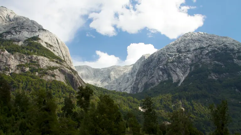 Paredes de granito del Anfiteatro sobre el bosque nativo del Valle Cochamó, en un día con nubes
